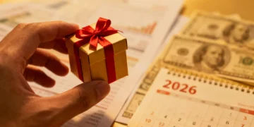 Hand holding a gift box symbolizing the 2026 gift tax exclusion limit